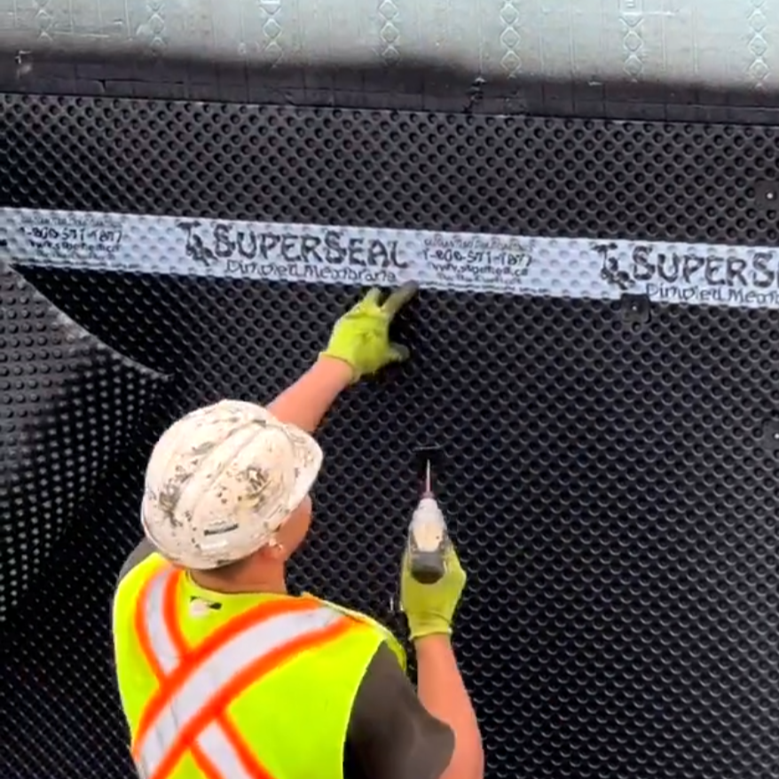 Installing SUPERSEAL Dimpled membrane over waterproofing on an ICF
