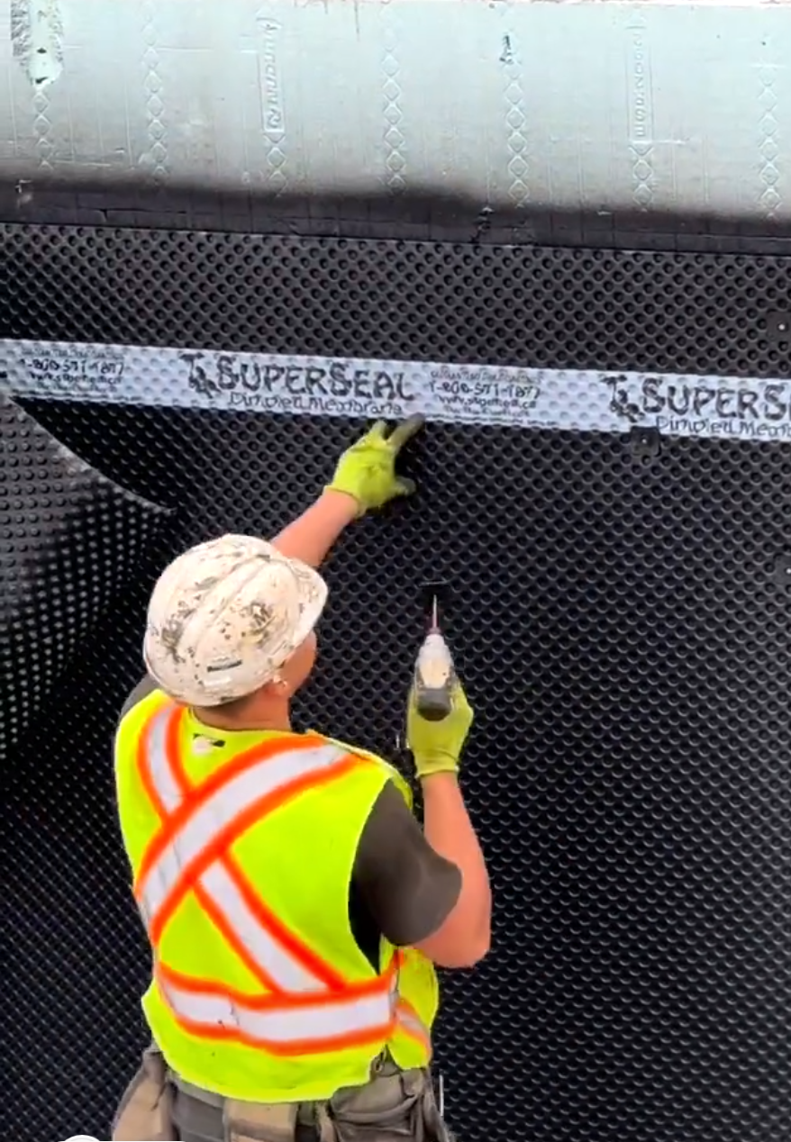 Installing SUPERSEAL Dimpled membrane over waterproofing on an ICF